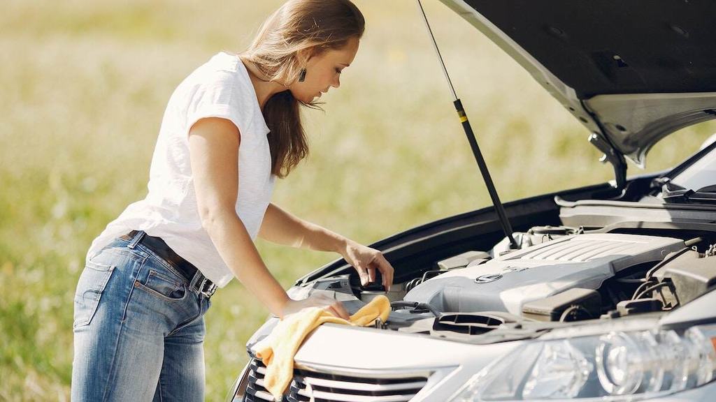 A woman repairing a car